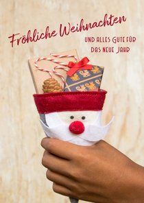 FairTrade-Weihnachtskarte mit Hand und Geschenken