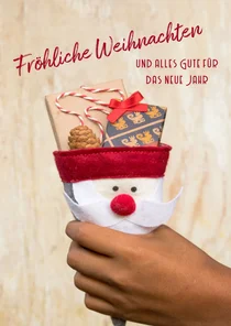 FairTrade-Weihnachtskarte mit Hand und Geschenken