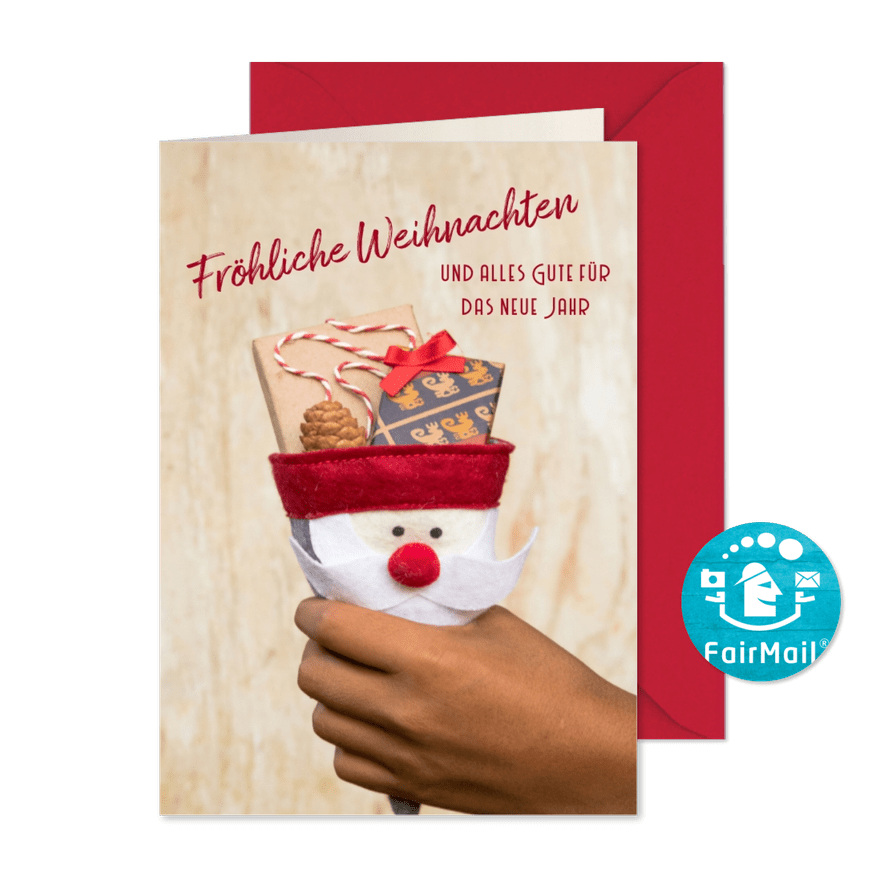 FairTrade-Weihnachtskarte mit Hand und Geschenken - Kartenvorschau